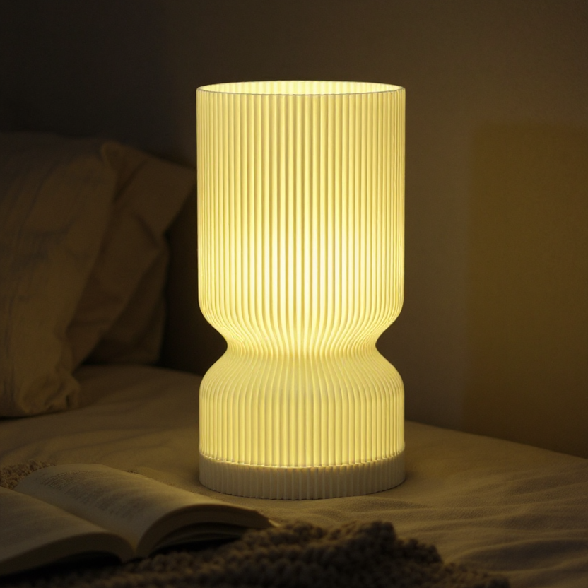 Warm, inviting glow from a modern, ribbed table lamp on a bedside table, soft ambient light casting gentle shadows across the room, a half-read novel lying open nearby, creating a cozy, relaxed atmosp